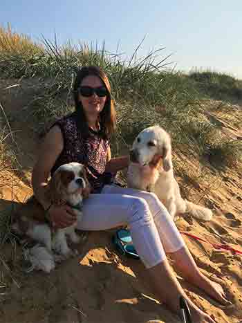Kate with her two dogs at the beach