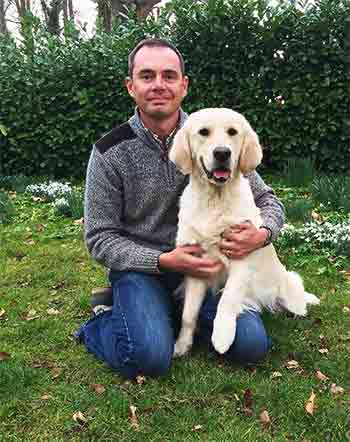 Marc, the owner of Westlodge Pet Hotel, with his Golden Retriever in the garden